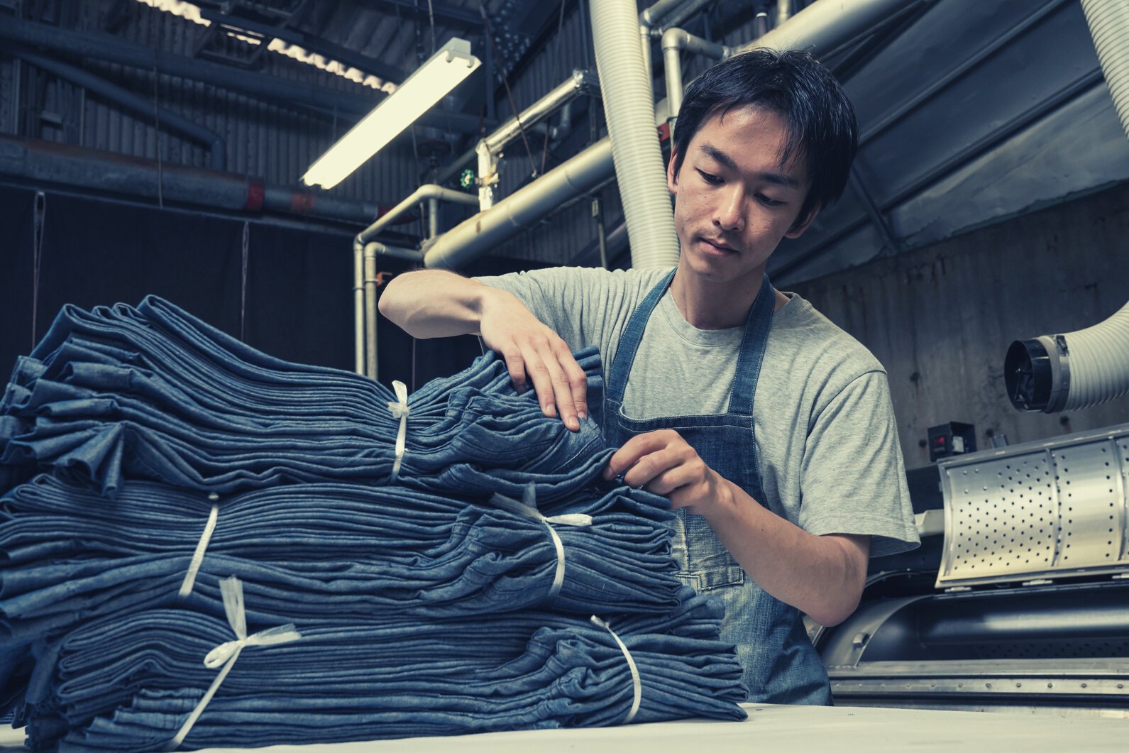 textile industry worker counting garments before shipping